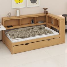 a bed with drawers underneath it in a room