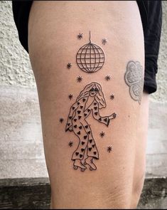 a woman's leg with tattoos on it and an image of a giraffe