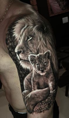 a man with a lion and cub tattoo on his arm