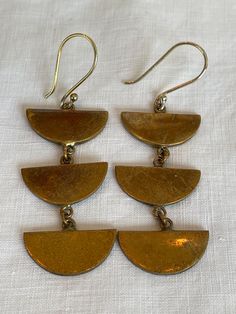 A pair of vintage brass dangle earrings. Cheap Brass Dangle Jewelry, Bronze Brass Drop Chandelier Earrings, Retro Brass Jewelry With Matching Earrings, Nickel-free Bronze Chandelier Earrings, Bronze Nickel-free Chandelier Earrings In Brass, Bronze Nickel-free Brass Chandelier Earrings, Gold Drop Earrings With Antique Finish, Bronze Antique Finish Dangle Earrings, Handmade Bronze Vintage Plug Earrings