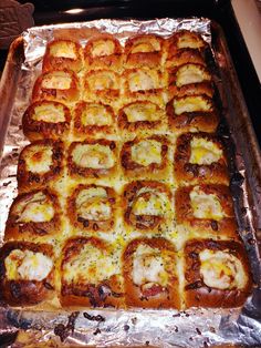 a pan filled with lots of food on top of a metal foil covered trays