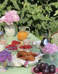 the table is set with fresh fruit and pastries