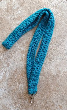 a blue crocheted lanyard is laying on the floor