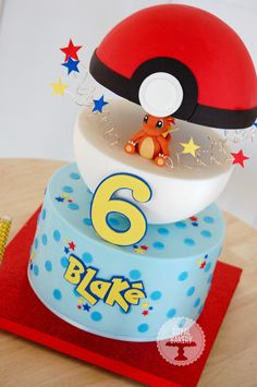 a birthday cake with a pokemon figure on top