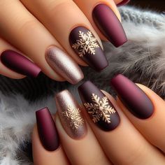 Elegant winter nail art with a matte finish in deep burgundy, adorned with gold snowflake accents Christmas Nails Dark Colors, December Nails Burgundy, Burgundy Winter Nail Designs, Christmas Elegant Nails Classy, Dark Red Christmas Nails Short, Burgundy Snowflake Nails, Dark Red Nails With Snowflake, Burgundy And Champagne Nails, Nail Color For Burgundy Dress