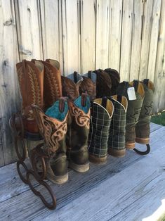 several pairs of cowboy boots lined up on a bench