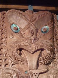 an intricate carved wooden mask with eyes