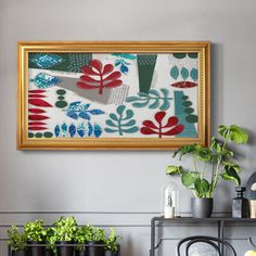 a painting hanging on the wall next to potted plants in front of a shelf