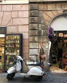 a scooter is parked in front of a store