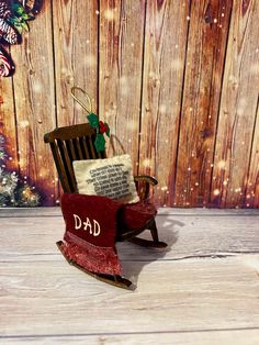 a wooden rocking chair with a christmas message on it