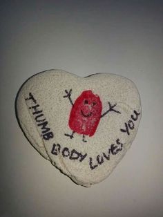 a heart shaped rock with writing on it