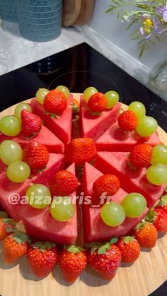 a watermelon and strawberries cake on a wooden platter