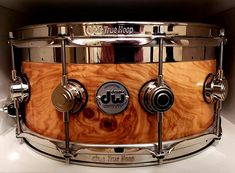 a close up of a drum on a white surface with metal hardware and knobs