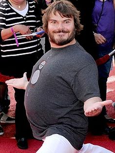 a man sitting on top of a red carpet