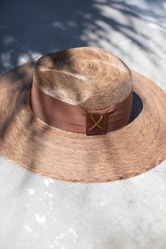 The most beautiful straw panama we've ever carried!! The glamorous Riviera hat is the perfect straw hat to offer full sun protection. Its body is braided by artisan hands and interlaced with palm leaves to create the finished design. Hat has a sealer on it making it water resistant. The construction of this hat is incredible. It’s completed with a rustic cotton braided trim. Features an inner elastic band for a OSFM fit! 100% Palm leaf, natural color (One Size) Standard Medium 58 cm Crown 4” Bri Luxury Wide Brim Fedora For Beach, Luxury Wide Brim Panama Hat For Beach, Luxury Wide Brim Fedora For The Beach, Luxury Wide Brim Boater Hat For Summer, Luxury Brimmed Panama Hat For Beach, Luxury Summer Straw Fedora Hat, Luxury Brimmed Straw Hat For Summer, Luxury Beach Fedora With Curved Brim, Luxury Curved Brim Fedora For Beach