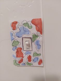 a white light switch with colorful designs on it