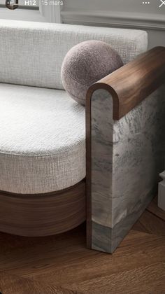 a white couch sitting on top of a wooden floor