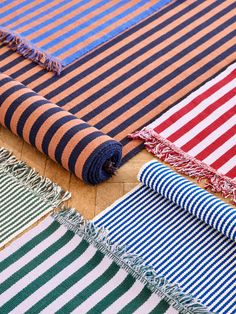 many different colored and striped rugs laid out on top of each other