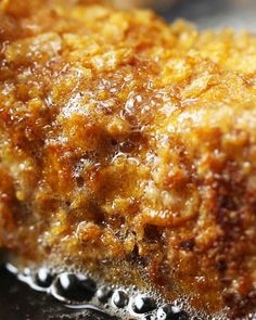 closeup of food with oil on it sitting on a table next to water droplets