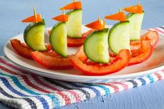 a white plate topped with cucumber and tomato boats