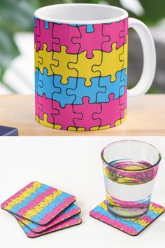 a colorful mug and coasters are on the table next to a cup with water in it