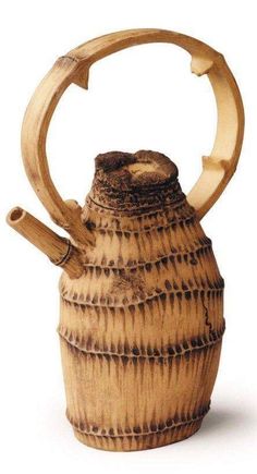 a wooden teapot with a handle made out of bamboo