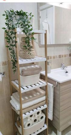 a bathroom with a sink, towel rack and toilet