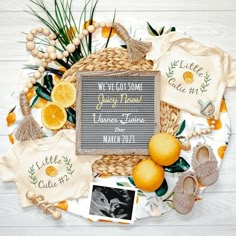 a baby announcement surrounded by lemons and other items