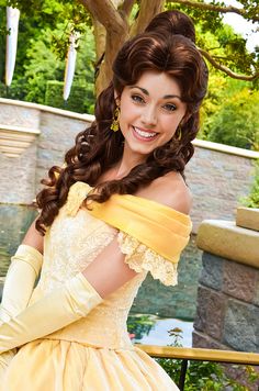 a woman in a yellow dress posing for the camera