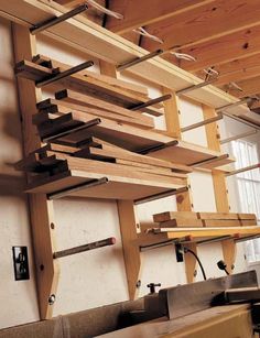 the shelves are made out of wood and have metal bars attached to them in order to hold items