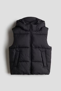 Puffer vest in quilted  woven fabric. Detachable hood  stand-up collar  zipper at front  and welt front pockets. Gathered seam at hem. Taffeta lining. Black Superpuff Vest, Black Puffer Vest Leather, Black Puffy Vest, Kids Sports Room, Black Quilted Nylon Vest, Kids Puffer Vest, Girls Puffer Vest, Womens Puffer Vest, Black Barn