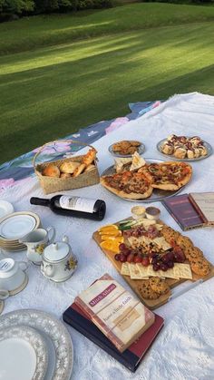 an outdoor picnic with food and drinks on the table