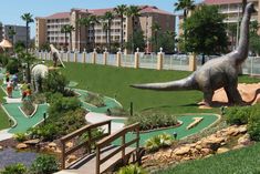 an artificial dinosaur golf course in the middle of a park