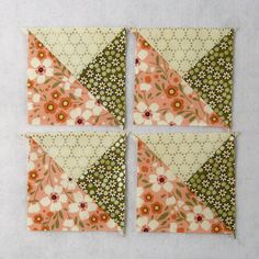 four pieces of fabric are arranged in the shape of squares with flowers and leaves on them