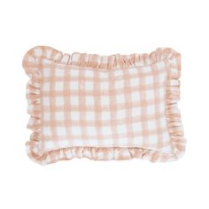 a pink and white checkered pillow with ruffles on the bottom, in front of a white background