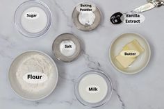 the ingredients for making cheesecakes are shown in bowls on a marble countertop