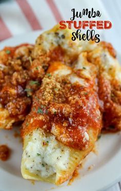 stuffed shells on a white plate with sauce and parmesan cheese in the middle