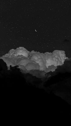 black and white photograph of the night sky with clouds, stars and moon in the distance