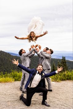 the bride and groom are jumping in the air