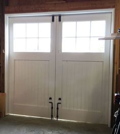 an open garage door with two black handles