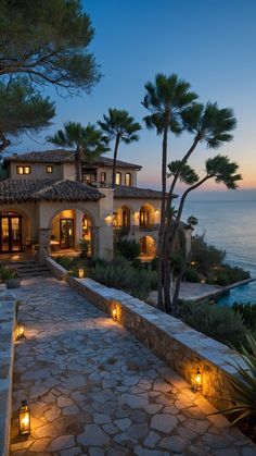 a large house with many lights on the walkway