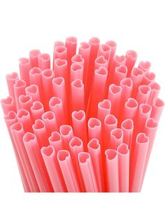 pink straws with hearts on them are lined up in a pile, against a white background