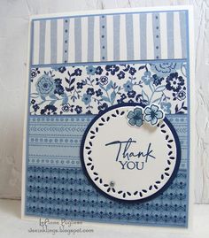 a blue and white thank you card with flowers on the front, an embellished circle at the bottom