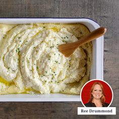 a bowl of mashed potatoes with a wooden spoon in it and a woman's face next to it