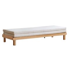 a wooden bench with a white mattress on it's back legs and bottom end