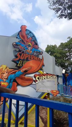 the sign for supergirl is on display at an amusement park