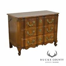 an old wooden dresser with many drawers on it's sides and gold knobs