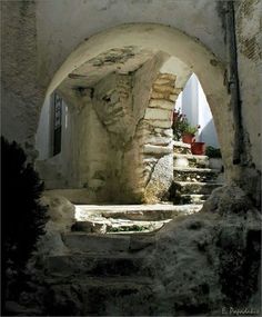 an arched doorway with steps leading up to it