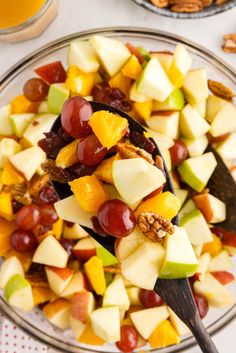 a bowl filled with fruit and nuts on top of a table