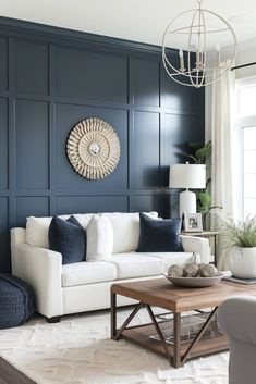 a living room with blue walls and white furniture in the center, along with a coffee table